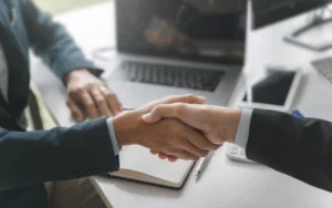 two business men shake hands whilst discussing what is B2B SEO.
